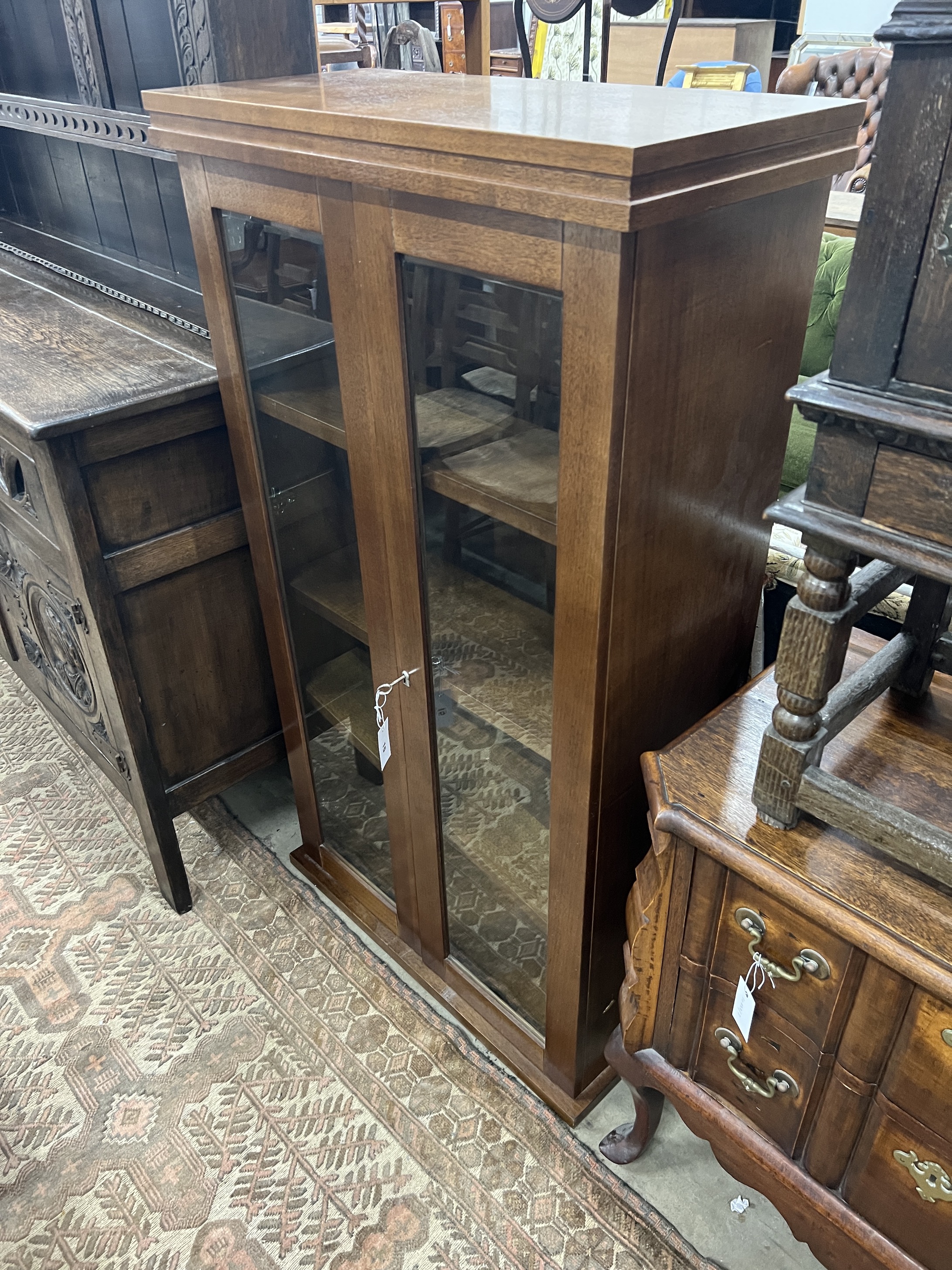 A South African mahogany glazed two door bookcase, width 75cm, depth 35cm, height 135cm